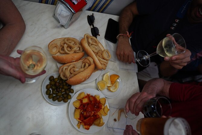 Madrid by Night: Tapas Crawl, Local Drinks & Hidden Gems - Plaza Mayor Bites: Bocadillo de Calamares and Croquettes at an 1860 Tavern